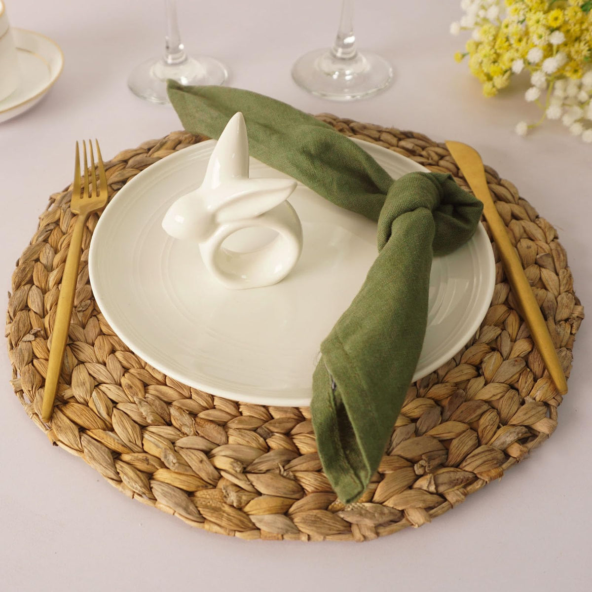 utalek easter table setting with colorful napkins and white bunny rings