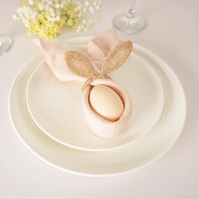 Utalek napkin rings shown on linen napkin in an elegant setting