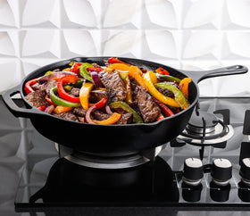 Utopia Kitchen premium cast iron skillet searing steak to brown crust evenly.