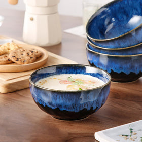 Vancasso Starry blue bowls arranged on dining table for elegant presentation.