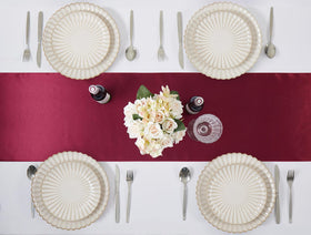 VCUSUELER burgundy satin runner paired with candles creates warm ambiance at events