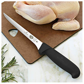 Victorinox Fibrox 6-Inch Boning Knife held in hand shows secure non-slip grip in wet kitchen conditions.