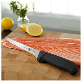 Victorinox Fibrox 6-Inch Boning Knife on a cutting board ready for prep.