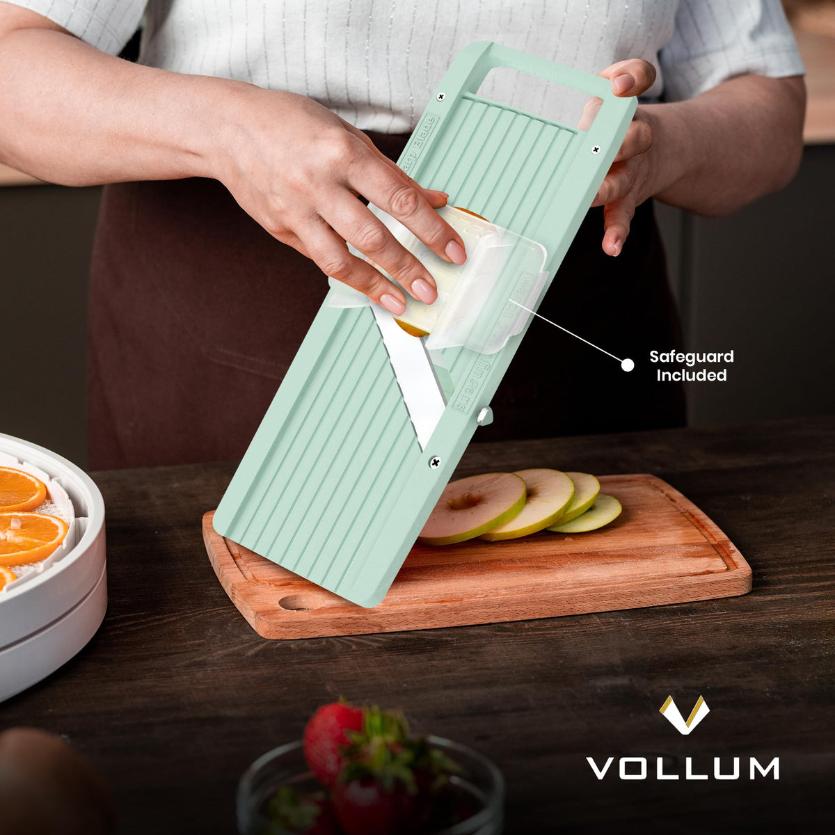 Vollum vegetable slicer in action slicing cucumbers, potatoes, and carrots.