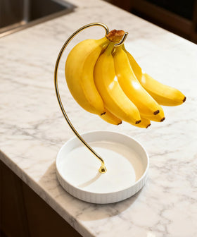 VROOMIUM banana holder on a countertop showcasing its space-saving design.