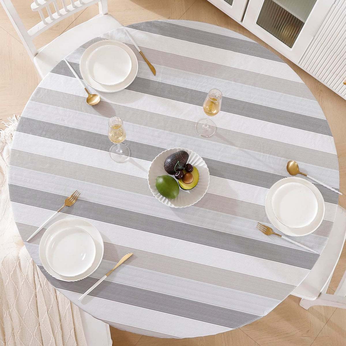 Walrus round vinyl tablecloth with flannel backing provides a snug, spill-resistant dining surface.