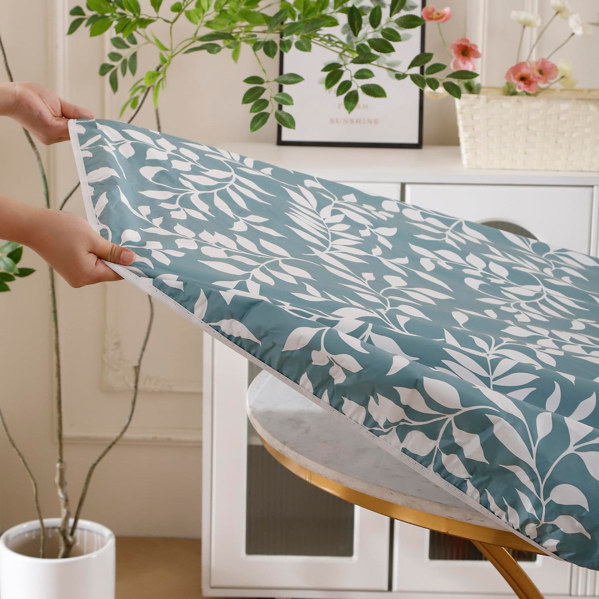 Walrus round vinyl tablecloth shows waterproof PVC surface that wipes clean.