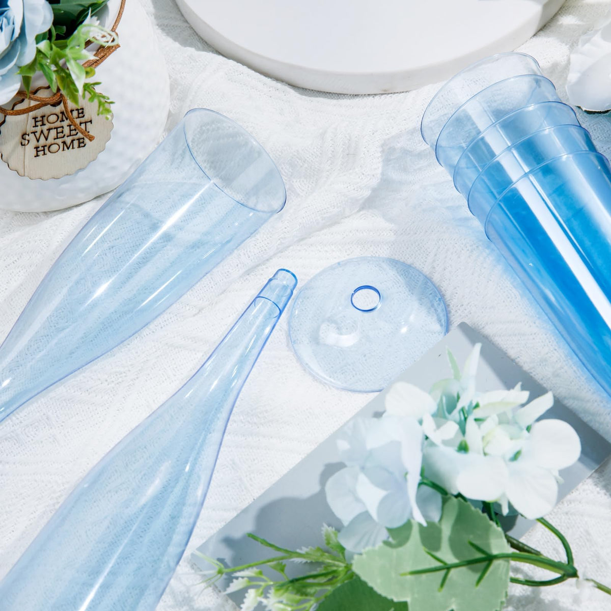 WDF blue 7oz plastic champagne flutes in use at a festive gathering.
