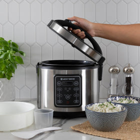 Included rice spoon and measuring cup with West Bend cooker setup