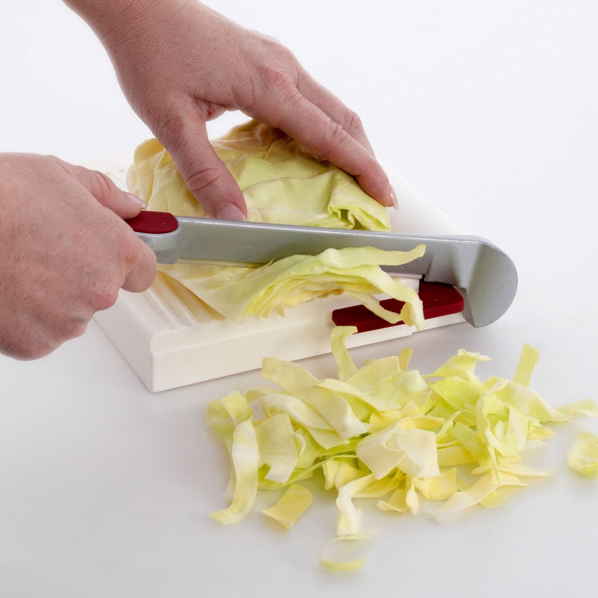 Westmark multipurpose slicer in action for cheese, sausage, or vegetables.