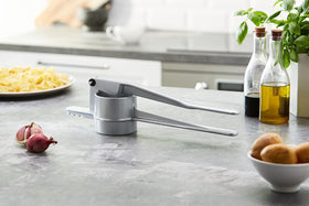 Westmark Spätzle press with hinged handles for easy, controlled pressing.