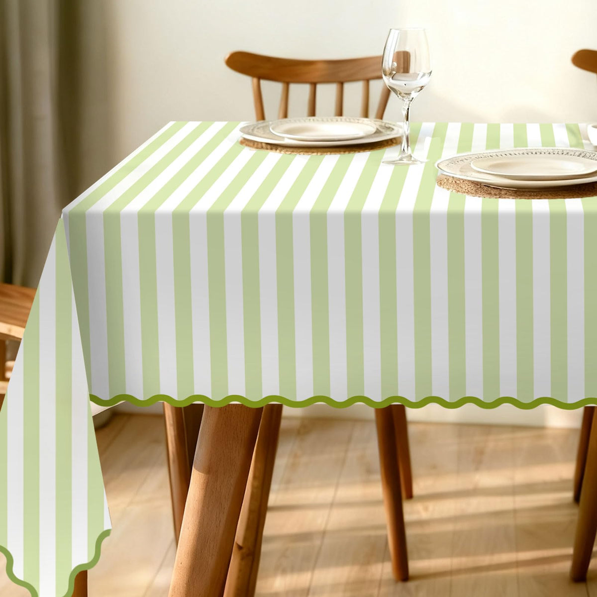Whaline scalloped-edge green striped tablecloth for elegant table setups.