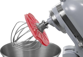 Whisk Wiper PRO red cleans the bowl edges after mixing batter.