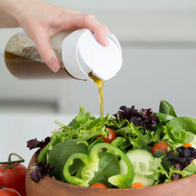 Whiskware Salad Dressing Shaker spout in use for one-handed pouring and spill-free serving.