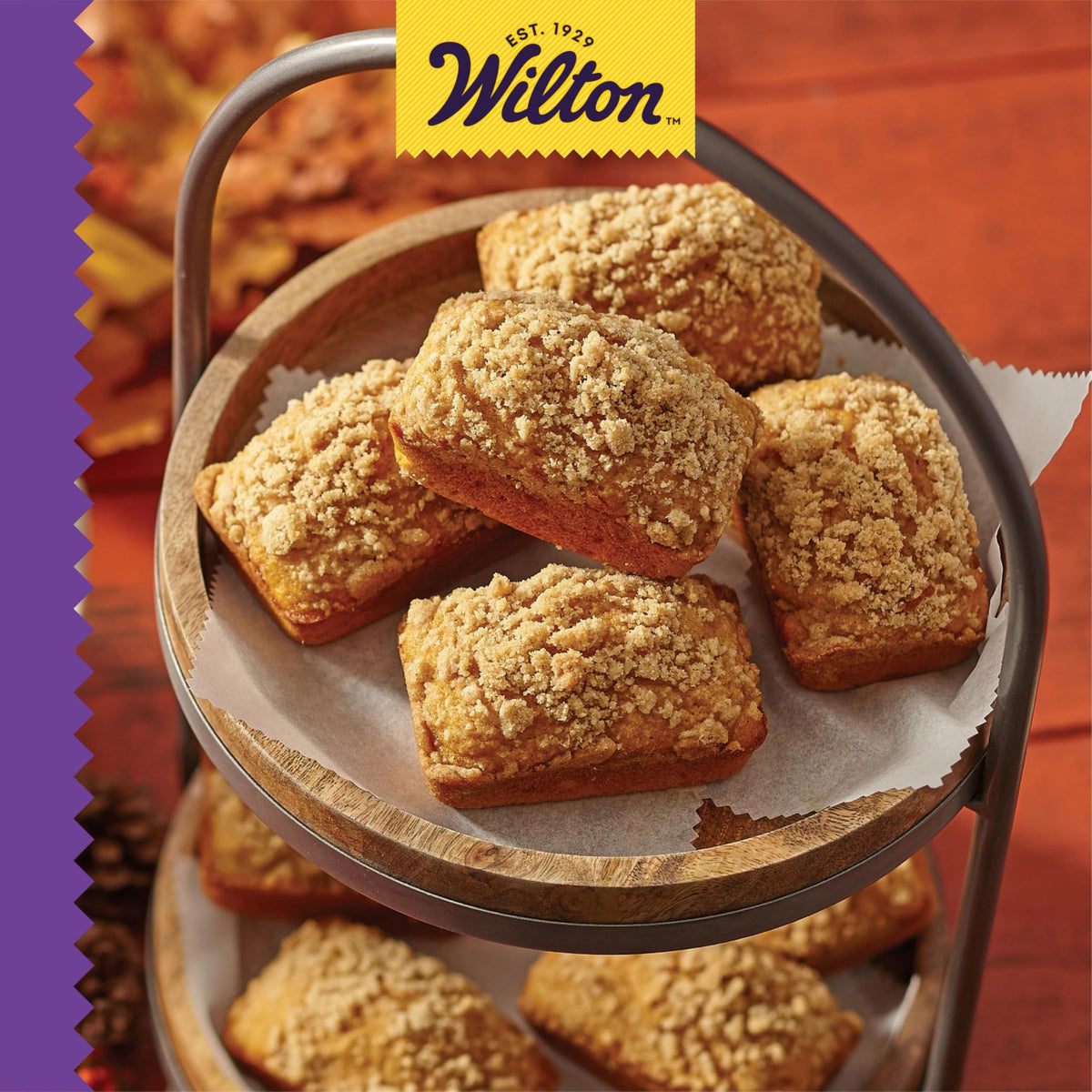 Wilton Gold Mini Loaf Pan with extended handles for safe handling and dishwasher-safe cleaning.
