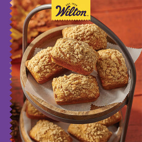 Wilton Gold Mini Loaf Pan with extended handles for safe handling and dishwasher-safe cleaning.