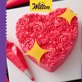 Frosted heart cake made with Wilton pan showcases clean edges.