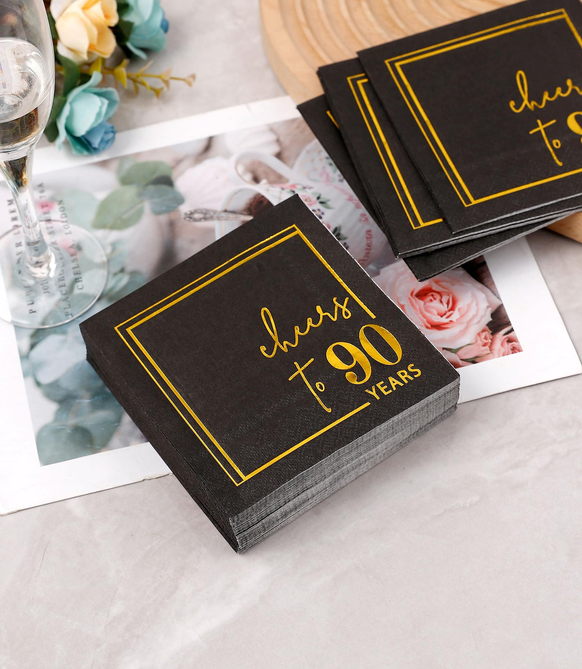 Winoo Design black and gold sparkle napkins elevate anniversary party table decor.