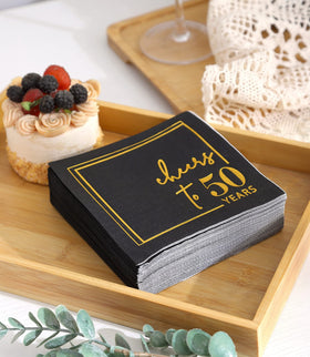 Winoo Design Cheers to Years 5x5-inch folded napkins on table
