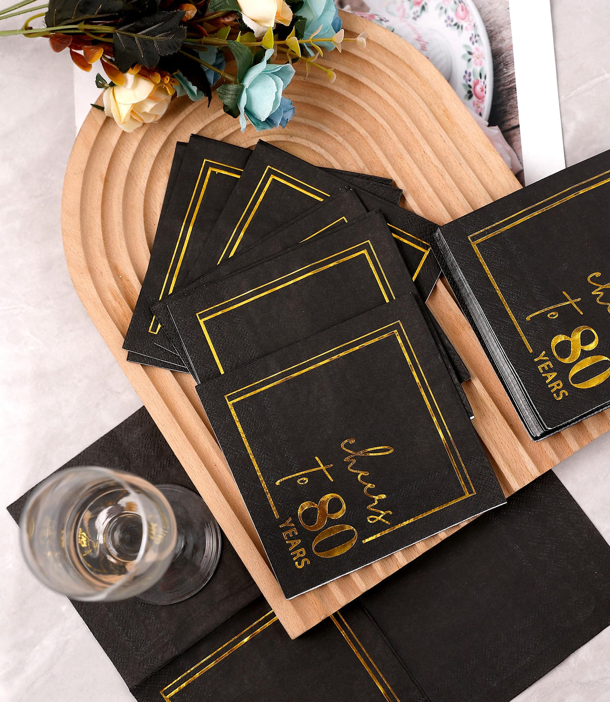 Winoo Design table setting with black and gold sparkle elevates celebrations.