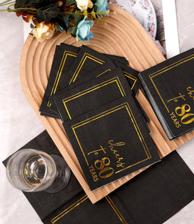 Winoo Design table setting with black and gold sparkle elevates celebrations.