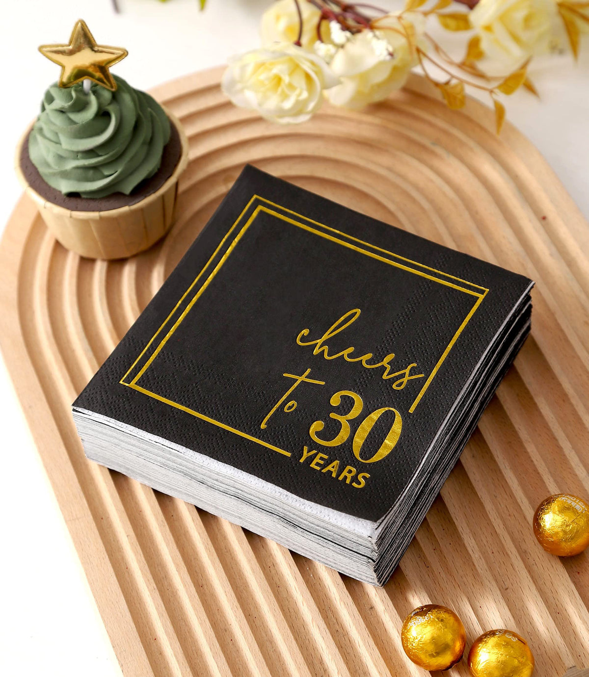 Napkins displayed on a celebratory table with black-gold sparkle for anniversaries