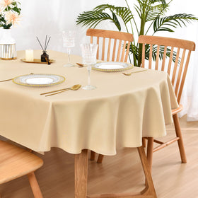 Wolkemer oval tablecloth 60x84 beige draped on a dining setup, elevates ambiance for gatherings.