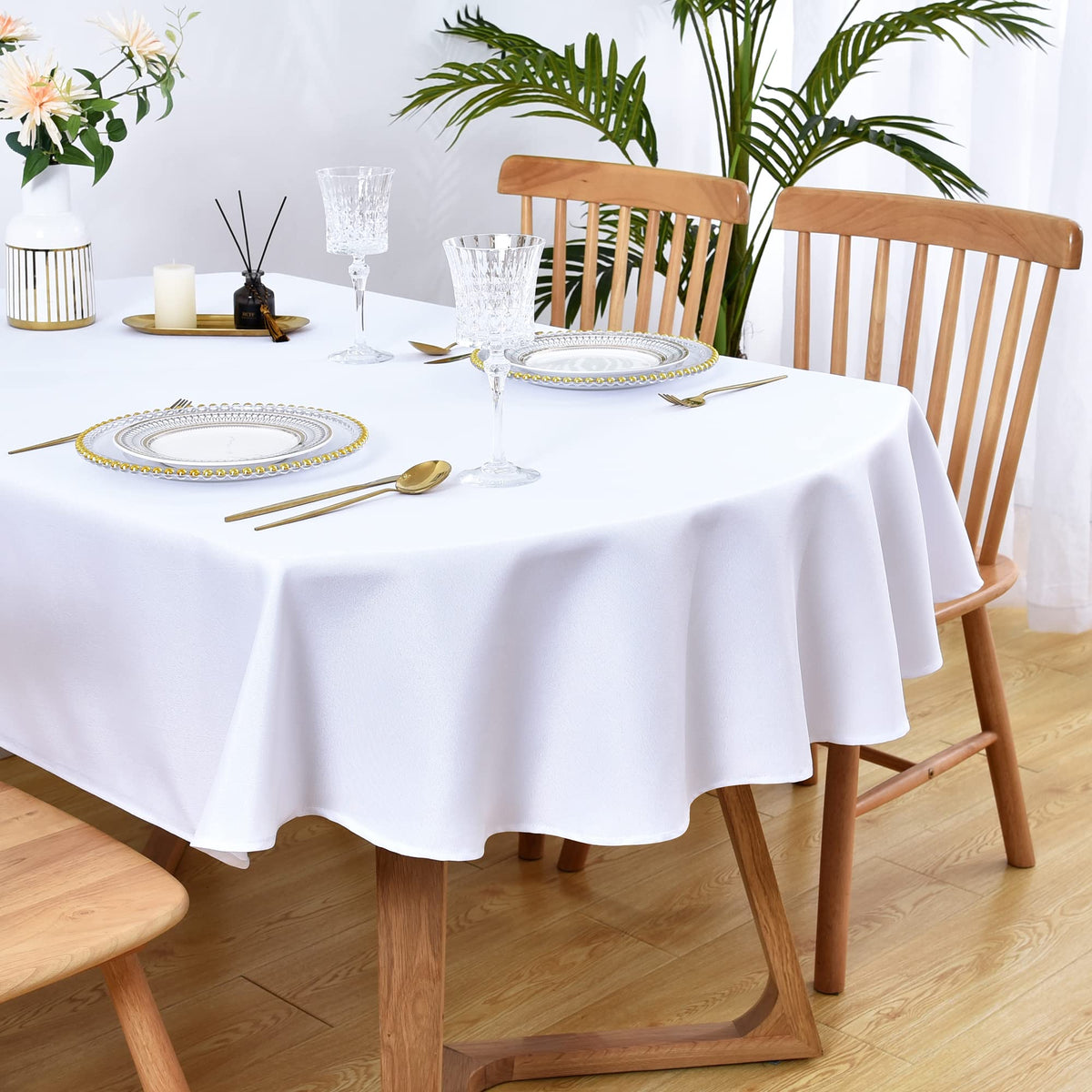 Wolkemer oval tablecloth 60x84 on table adds clean white elegance.