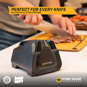 Work Sharp E2 sharpening a blade with automated angle control.