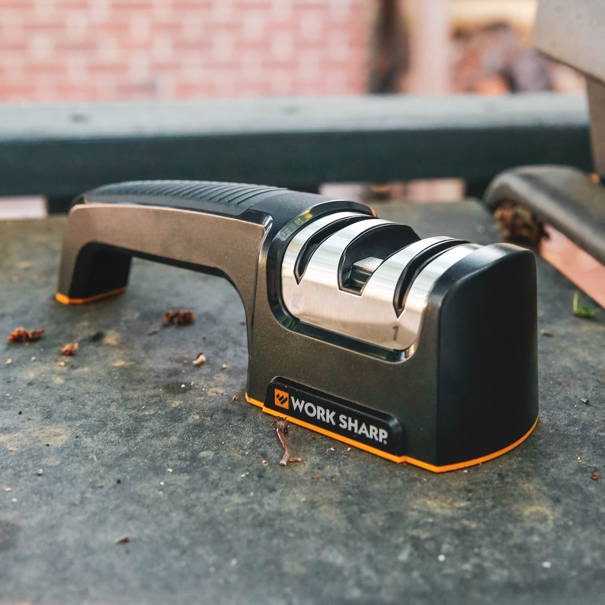 Work Sharp Pull Through sharpening a chef knife edge for precise slicing.