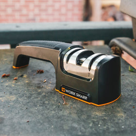 Work Sharp Pull Through sharpening a chef knife edge for precise slicing.