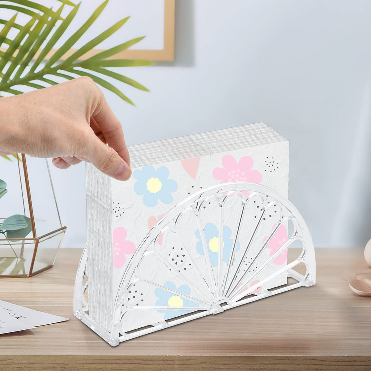 Worldity clear napkin holder with wide base for stable placement on surfaces.
