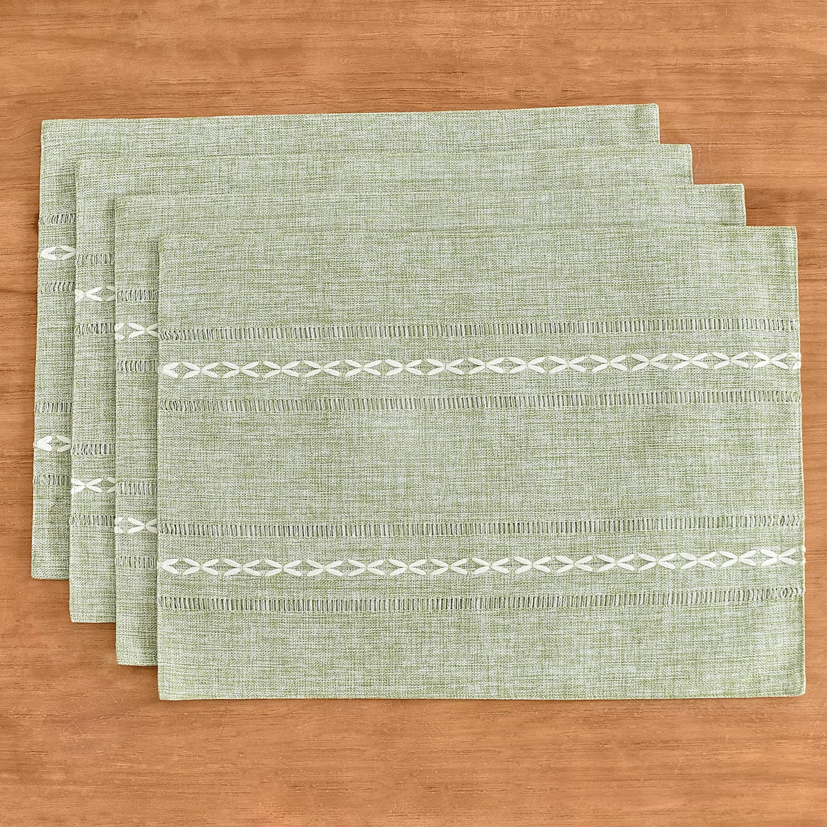 Wracra sage-green placemats set a warm, inviting dining ambiance.