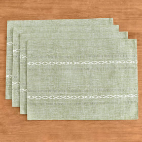 Wracra sage-green placemats set a warm, inviting dining ambiance.