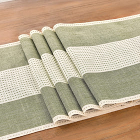 Close-up of Wracra linen runner macrame edges adding texture to a table