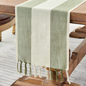Wracra linen table runner in sage green with macrame fringe for rustic dining ambiance