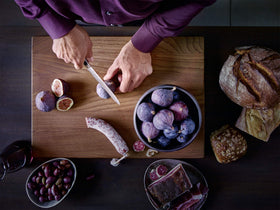Wüsthof Classic IKON 8-Inch chef in action slicing vegetables and meats.