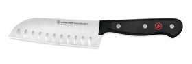 WÜSTHOF Gourmet 5-inch hollow edge santoku blade close-up for precise slicing.