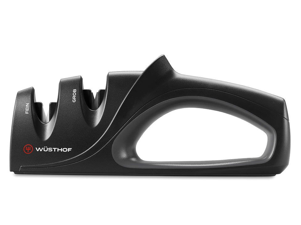 Wüsthof two-stage hand-held sharpener in coarse stage sharpening dull blades.