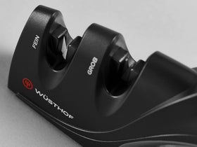 Wüsthof sharpener ergonomic-handle in-use delivers safe, controlled sharpening.