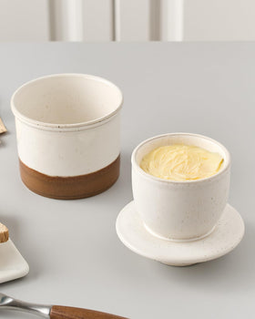 Xela butter crock latte lid-off close-up emphasizing water line and serving ease