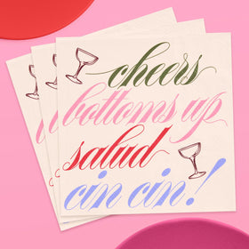 xo Fetti Cheers cocktail napkins on a bar cart elevate toasts with a clean backdrop.