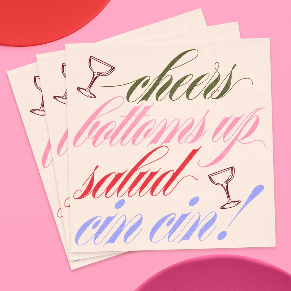 xo Fetti Cheers cocktail napkins on a bar cart elevate toasts with a clean backdrop.