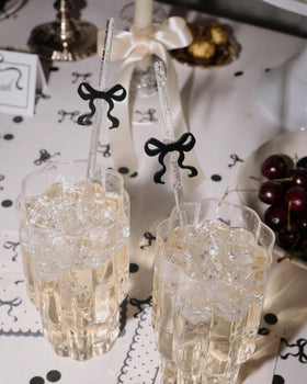 Removable acrylic bow topper on xo Fetti straw enhances take home party favors