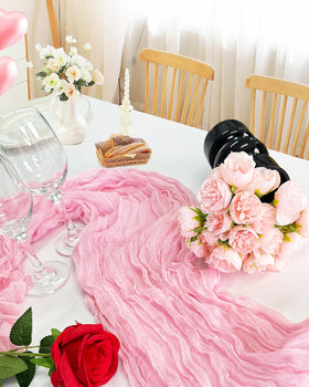 Xuehua pink cheesecloth runner framing a dessert table centerpiece