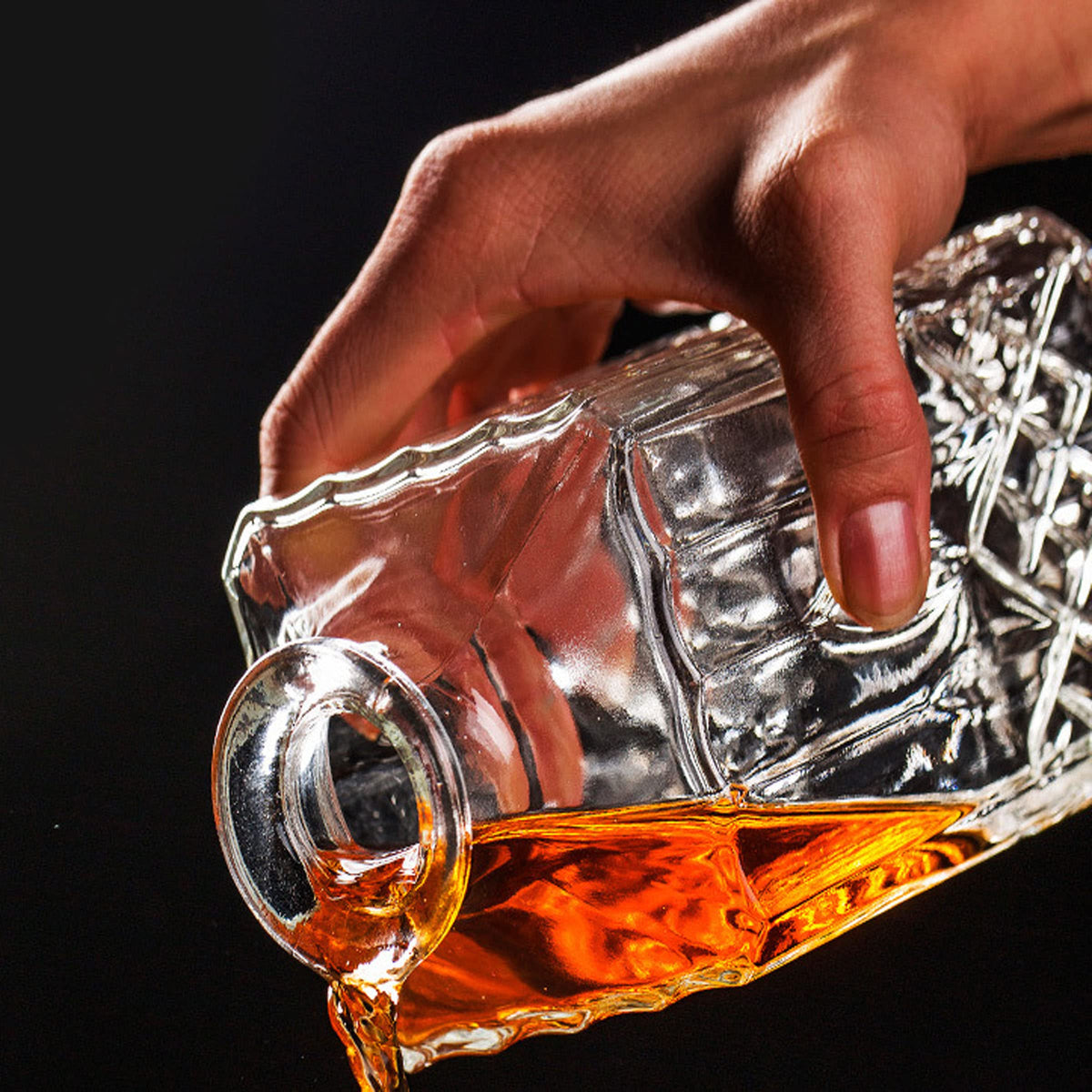 XXYXXY Diamond Decanter hand-pour demonstrating comfortable grip.