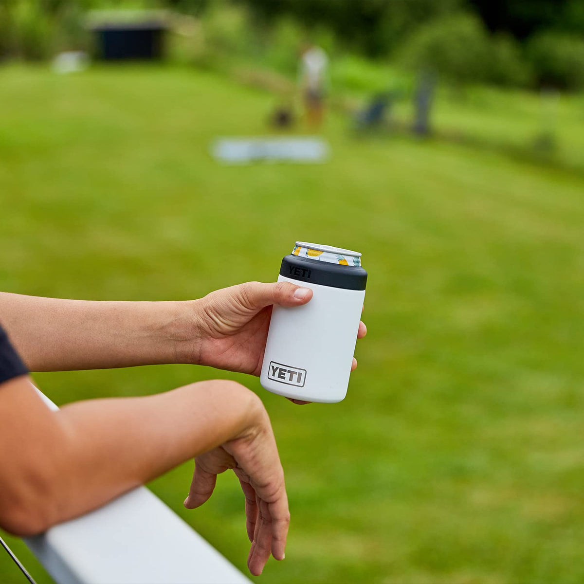 Outdoor setup with white YETI Colster and standard cans