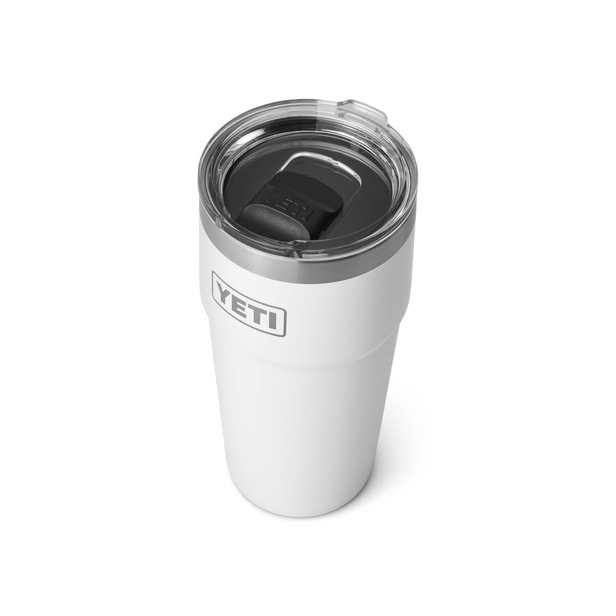 YETI Rambler 20 oz stackable tumbler beside a dishwasher highlighting easy cleanup.
