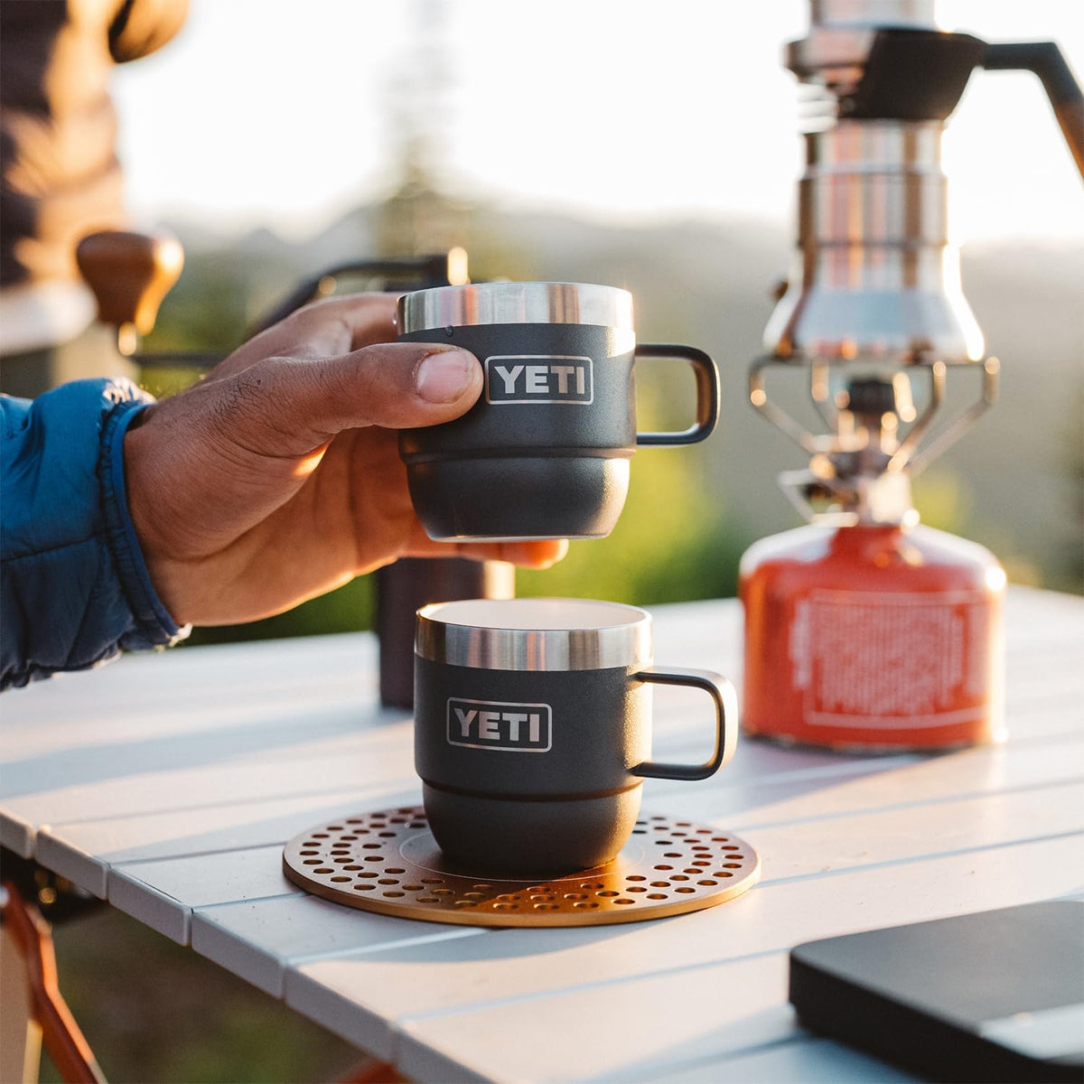 YETI Rambler 6 oz stackable mug outdoors, Rescue Red perfect for adventures.