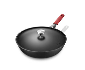 Yonida carbon steel pan with lid on stove showing even heat distribution for tasty sears.